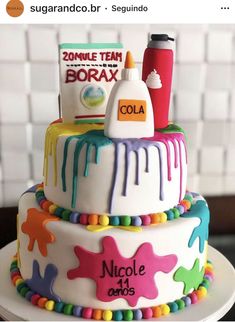 a three tiered cake with colorful icing on it