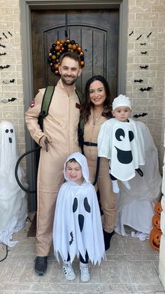 two adults and one child dressed up in halloween costumes