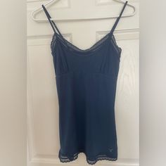 95% Cotton 5% Spandex Blue Stretch Camisole With Built-in Bra, Blue Seamless Elastane Tops, Blue Seamless V-neck Camisole, Blue V-neck Seamless Camisole, Blue Fitted Tank Top For Loungewear, Blue Stretch Camisole For Loungewear, Stretch Blue Camisole For Loungewear, Fitted Blue Camisole With Lace Trim, Blue V-neck Tops With Built-in Bra