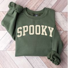 This spooky halloween sweatshirt featuring bold collegiate lettering makes the perfect gift anyone who loves the holidays.  🍀 Size up to achieve that trendy oversized look, or choose your go-to size for a perfect fit. 🍀 For more bookish merch, be sure to check out the other products in my store 🍀 Don't forget to "Follow Shop" to stay up-to-date on new products and sales. About your new sweatshirt: 🍁 Quality 🍁 Comfort🍁 Durability 🍁 Made using 100% Cotton for 🍁 Unmatched durability 🍁 Exce Cute Sweaters For Fall, Spooky Sweatshirt, Halloween Crewneck, College Halloween, Stay Spooky, Halloween Sweater, Sweatshirt Halloween, Fall Gifts, Halloween Sweatshirt