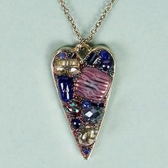 "This JEWELED DIMENSIONAL HEART NECKLACE with was handcrafted by Sandi Obertin.  The metal heart is approximately 1-1/8\" x 2\" and is embellished with shades of blue, lavender and silver glass accents.   It comes with a silver colored 16\" metal chain and is ready to wear.  It would be a perfectly lovely special occasion gift... wedding, anniversary, engagement, birthday...  You will get this ONE-OF-A-KIND BEADED MOSAIC NECKLACE #H1" Heart-shaped Necklace With Colorful Beads For Parties, Purple Heart Beads Jewelry For Party, Party Heart-shaped Beaded Necklaces With Heart Beads, Beaded Heart Necklace For Parties, Heart-shaped Beaded Necklace For Parties, Party Beaded Heart Necklace, Heart Beaded Necklaces For Parties, Party Heart Shaped Beaded Necklace, Party Beaded Necklaces With Heart Pendant