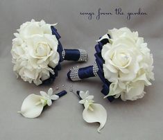 the bridal bouquets and boutonnieres are all white flowers with blue ribbon