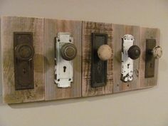 an assortment of knobs and pulls are mounted on a wall