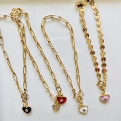 Loving these new heart charm bracelets. Something about them reminds me of the playfulness of childhood, but with an updated elegant (and adult) twist. These enamel charms are available in red, light pink, white, and black, and are all accented with a cubic zirconia. Charm also available in a cubic zirconia heart. If you like the looks of how some are styled in the pictures with multiple charms, please contact me for a customizable bracelet. Otherwise, each bracelet comes with 1 charm. Charms ar Trendy White Heart Charm Bracelet, Red Heart Charm Bracelet For Friendship, Red Heart Charm Jewelry For Friendship, Heart-shaped Charm Bracelet With Dangling Charms For Valentine's Day, Heart-shaped Friendship Charm Necklaces, Heart-shaped Jewelry With Removable Charms For Valentine's Day, White Heart-shaped Metal Charm Bracelet, Heart Charm Necklace For Friendship, Heart-shaped Charm Necklaces With Removable Charms