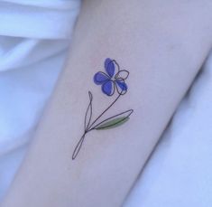 a small blue flower on the arm