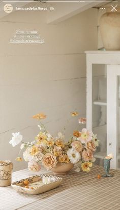 a vase filled with flowers sitting on top of a table