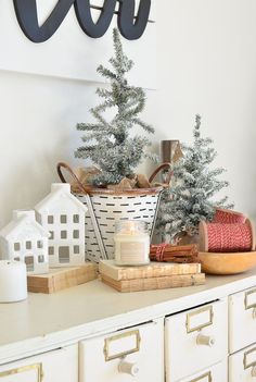 a white christmas tree sitting on top of a dresser