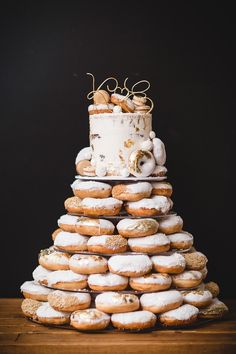 a cake made out of doughnuts sitting on top of a wooden table