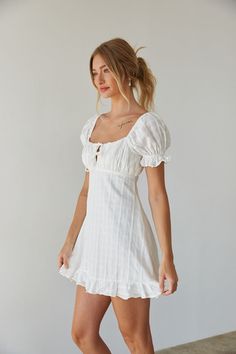 Prepare to blossom in the Clover Puff Sleeve Gingham Mini Dress this Spring Summer! This babydoll mini dress is ready for sunny days and daydreaming; featuring darling puff sleeves, an open back silhouette, tie front bustier detail. Available in white and sage green with a subtle gingham print. Pair this sundress with a pair of cowboy boots to complete the outfit! Details Shell: 100% Cotton Lining:100% Polyester Back zipper and button up closure Elastic sleeves Partially lined Hand Wash Cold Puff Sleeve Mini Dress With Ruffles For Picnic, White Puff Sleeve Mini Dress With Smocked Back, White Puff Sleeve Dress With Tie Back For Brunch, Fitted Puff Sleeve Mini Dress For Picnic, White Puff Sleeve Dress With Sweetheart Neckline For Summer, White Mini Dress With Square Neck For Picnic, White Square Neck Mini Dress For Picnic, Cute White Puff Sleeve Dress For Brunch, Classic Summer Dresses