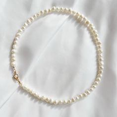 Genuine freshwater pearls & toggle clasp. Length: approx 17” Genuine 6-7mm freshwater pearls & 14k gold filled toggle clasp. Does not turn, tarnish, or rust. Each natural pearl is unique and therefore no two are alike. Pearls, colors and sizes may vary. Handmade with the highest standards & quality materials. Includes 100% organic cotton jewelry pouch. This item is made to order and shipped with love from our studio located in West Chester, PA. *Click here to learn more about gold filled jewelry Everyday Single Strand Baroque Pearl Necklace, Pearls Colors, Cotton Jewelry, West Chester Pa, Mama Necklace, Double Wrap Bracelet, Toggle Necklace, West Chester, Meaningful Jewelry