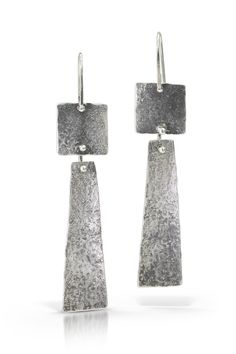 Sterling Silver Earrings - A rough texture contrasts with the long and elegant shape of these sterling silver earrings.  Theyve been oxidized to highlight texture.  From the top of the ear wire to the bottom of the earring, they are about 2 and a half inches long. Artisan Sterling Silver Dangle Earrings, Hand Forged Long Drop Modern Earrings, Rustic Silver Dangle Earrings, Artisan Long Drop Silver Earrings, Sterling Silver Oxidized Dangle Earrings, Rustic Sterling Silver Dangle Earrings, Modern Sterling Silver Linear Earrings With Hammered Detail, Hammered Sterling Silver Long Drop Earrings, Modern Sterling Silver Hammered Linear Earrings