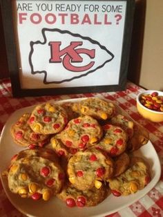 a plate full of chocolate chip cookies with candy corn on the side and a bowl of cereal