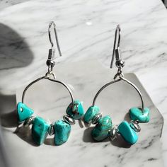 These beaded hoop earrings are made with turquoise jasper nuggets and silver  beads and accented with silver plated wires. The earrings measure 2 inches (5.08 cm) in length.   I ship internationally to anywhere in the world and your earrings will come in protective packaging.   Please see my Policy page for further information: http://www.etsy.com/shop/KNITTEDLtd/policy?ref=shopinfo_policies_leftnav Want to see more of my earrings, click here:  www.etsy.com/shop/KNITTEDLtd Turquoise Hoop Earrings With Dangling Beads As Gift, Turquoise Dangle Hoop Earrings Nickel Free, Turquoise Hoop Earrings With Round Beads, Turquoise Earrings With Silver Round Beads, Turquoise Wire Wrapped Dangle Hoop Earrings, Adjustable Turquoise Hoop Earrings With Colorful Beads, Turquoise Dangle Hoop Earrings Wire Wrapped, Turquoise Dangle Hoop Earrings With Colorful Beads, Nickel-free Turquoise Metal Hoop Earrings