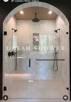 a shower with the words dream shower on it's glass door and an arched window