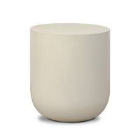 a white vase sitting on top of a table