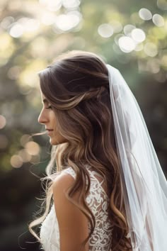 a woman wearing a wedding veil and looking off into the distance