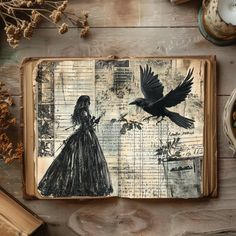 an open book with a drawing of a woman and a bird on it, surrounded by other items