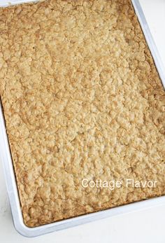 a square pan filled with oatmeal sitting on top of a white table