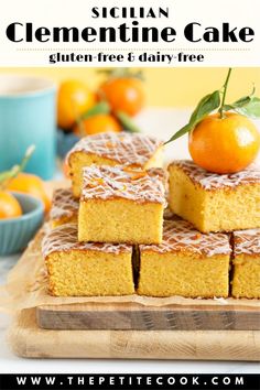 several pieces of cake sitting on top of a cutting board with oranges in the background