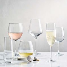 several wine glasses are lined up on a table