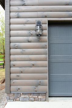 a gray garage door with a light on it