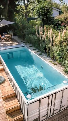 an above ground swimming pool made out of shipping containers