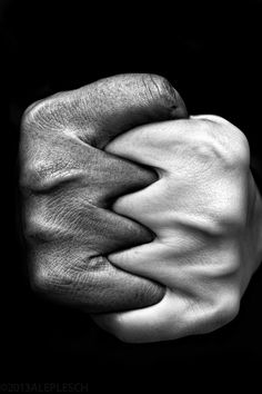 black and white photograph of two hands holding each other