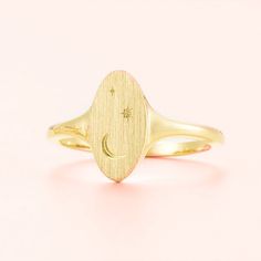 Adorn your finger with the Celestial Signet Ring, a unique and inspiring piece crafted in 14k gold or silver. Featuring a striking moon and stars motif, this celestial ring is a piece of art that reflects your own unique style and shines with high-quality. Make a statement with this stunning accessory!RING LAYOUT  Ring Width: 13 mm tapered to 2 mm Ring Sleeve:14KGold or Sterling Silver Ring Profile:Round Ring Finish:Brushed Top, Polished Shank Jewelry By Johan, Engraved Wedding Rings, Celestial Ring, Colored Engagement Rings, Round Rings, Moon And Stars, Ring Sizer, Engraved Rings, Accessories Rings