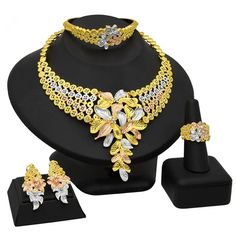 Indulge in luxury with this exquisite Necklace Set, perfect for wedding parties. With its opulent design and superior craftsmanship, this set features a necklace, bracelet, earrings, and ring. Make a lasting impression and elevate your style with this luxurious jewelry set.” Wedding Jewelry Sets With Plated Cubic Zirconia, Wedding Cubic Zirconia Plated Jewelry Sets, Party Gold Plated Jewelry Set With Elegant Design, Exquisite Gold-plated Jewelry With Elegant Design, Yellow Gold Cubic Zirconia Jewelry Sets For Party, Gold Plated Costume Bridal Sets, Gold Plated Elegant Costume Jewelry, Elegant Fine Jewelry Sets For Party, Wedding Fine Jewelry Plated Necklaces