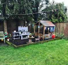 an outdoor garden area with wooden benches, potted plants and a grill in the middle