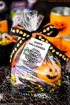 a bag filled with halloween treats sitting on top of a table