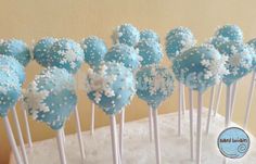 blue cake pops with white sprinkles on them