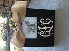 a monogrammed photo frame with a bow on the front and an initial in the middle