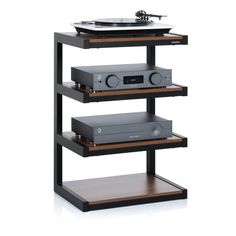 a record player sitting on top of a shelf next to a turntable and stereo