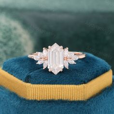 an engagement ring on top of a blue cushion