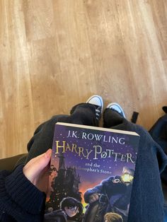 harry potter and the half - blood prince by j k rowling is shown in front of a wooden floor