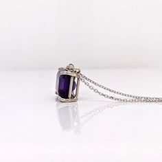 This gorgeous solitaire pendant features an emerald cut 10x8mm amethyst set in a solid 14k white, yellow, or rose gold setting. A perfect birthday gift for February babies, this magnificent purple gemstone will make any outfit sparkle and shine. Let your beauty shine! Choose between a 16" or 18" chain so we can make sure your pendant is perfectly centered! White Gold Birthstone Jewelry With Radiant Cut, White Gold Jewelry With Birthstone In Radiant Cut, White Gold Radiant Cut Birthstone Jewelry, Purple Radiant Cut Jewelry For Anniversary, Purple Rectangular Jewelry With Prong Setting, Emerald Cut Amethyst Birthstone Jewelry, Purple Emerald Cut Birthstone Jewelry, Classic Amethyst Oval Pendant Jewelry, Fine Jewelry White Gold Amethyst With Emerald Cut