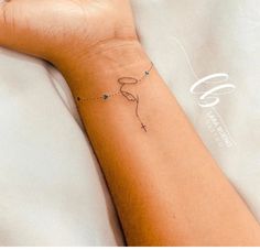 a person's arm with a small tattoo on it