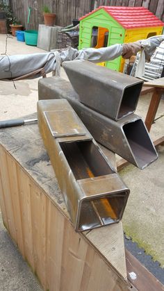 some metal pipes are sitting on top of a wooden box