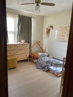 a bedroom with two beds and a ceiling fan