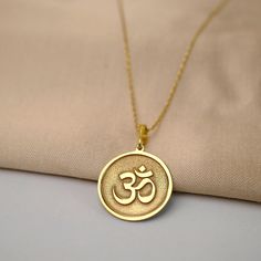 This exquisite Gold Om necklace pendant is a spiritual and stylish accessory that will elevate any outfit. Crafted with precision and care, this stunning pendant features a delicate Om symbol in shimmering gold. The Om symbol is a sacred sound and spiritual icon in Hinduism, Buddhism, and other religions, representing the oneness of all creation. Wear this beautiful necklace pendant as a daily reminder of peace, harmony, and unity. It also makes a thoughtful gift for friends and loved ones seeki Om Necklace, Om Charm, Spiritual Yoga, Om Symbol, Yoga Jewelry, Stunning Necklace, Personalized Necklace, Stylish Accessories, Buddhism