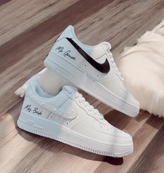 a pair of white nike air force sneakers