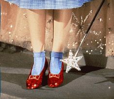 a woman's red shoes and blue socks with snowflakes on the ground