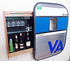 a vending machine with bottles and glasses in it