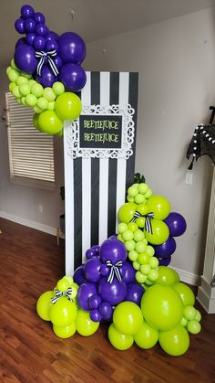 purple and green balloons are on the floor next to a sign that says reference before