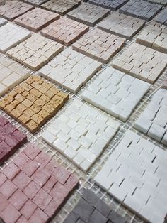 several different colored tiles arranged in rows on the ground with one yellow and one red