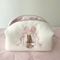 Finished Bunny and Bow Embroidered Makeup Bag Size: 20x10x9cm ✂️%100 cotton fabric. 🧼Washing Instructions: It can be hand washed. Please don't iron. 📦 Packaging: The products are shipped out within 1-2 working days. Cute Skincare Bags, Makeup Bags For School, Sewed Makeup Bags, Pink Makeup Pouch, Pretty Makeup Bag, Embroidered Cosmetic Bag, Customized Makeup Bag, Cute Cosmetic Bag, Custom Makeup Bag