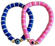 two pink, blue and white bracelets with gold bells on each strander in the shape of an eye