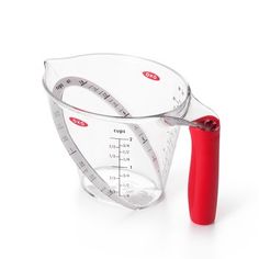 a measuring cup with a red plastic handle