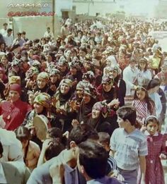 a large group of people standing around each other